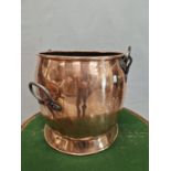 A 19th C. COPPER CAULDRON WITH TWO IRON HANDLES AND A THIRD OVER SWINGING THE CIRCULAR RIM. Dia.