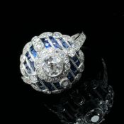 AN ART DECO STYLE SAPPHIRE AND DIAMOND RING. UNHALLMARKED, STAMPED PLAT, ASSESSED AS PLATINUM.