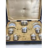 A CASED SILVER MOUNTED CRESCENT PORCELAIN COFFEE SET BY ALEXANDER CLARK, BIRMINGHAM 1928, EACH PIECE