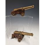 A PAIR OF ANTIQUE MINIATURE BRONZE DECK CANNON EACH WITH CAST WITH GEORGE III CREST AND MOUNTED ON