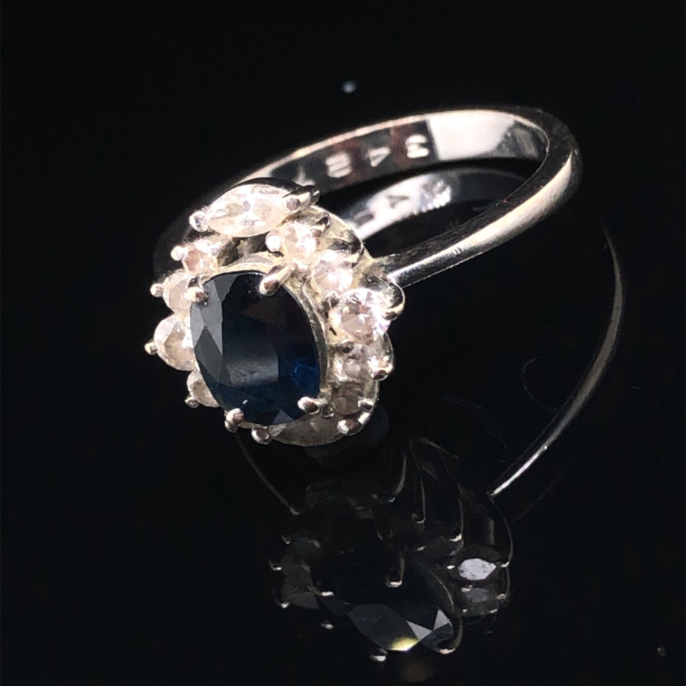 A SAPPHIRE AND DIAMOND CLUSTER RING. THE OVAL SAPPHIRE IN A FOUR CLAW SETTINGS, SURROUNDED BY TWO - Image 2 of 7