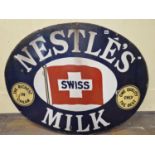 A NESTLES MILK OVAL ENAMEL SIGN, THE BLUE GROUND BORDER ENCLOSING THE SWISS FLAG CENTRALLY. W