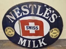 A NESTLES MILK OVAL ENAMEL SIGN, THE BLUE GROUND BORDER ENCLOSING THE SWISS FLAG CENTRALLY. W