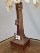 A ROBERT MOUSEMAN THOMPSON OAK CANDLESTICK SHAPED TABLE LAMP. h 27cms.
