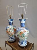 A PAIR OF CHINESE BALUSTER VASES AS LAMPS, EACH PAINTED WITH FAMILLE VERTE RESERVES OF A DRAGON