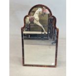 AN OGEE ARCHED MIRROR WITHIN A TORTOISESHELL FRAME. 72 x 41cms.