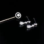 A PAIR OF DIAMOND SET DROP EARRINGS AND A DIAMOND SET STICK PIN. BOTH UNHALLMARKED, THE PIN HEAD