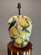 A MOORCROFT OVOID TABLE LAMP SLIP TRAILED WITH BLUE BIRDS ON LEMON BRANCHES AGAINST A CREAM