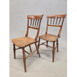 A PAIR OF OAK COUNTRY CHAIRS, THE BROAD TOP RAILS OVER RING TURNED SPINDLES, THE SADDLE SEATS ON