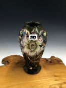 A MOORCROFT BALUSTER VASE SLIP TRAILED WITH SPIKEY HIBISCUS FLOWERS ON A DARK OLIVE GROUND, 1998