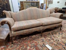 A 20th C. MAHOGANY SETTEE, THE SERPENTINE BACK, ROLL OVER ARMS AND SEAT UPHOLSTERED IN STRIPED
