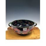 A WILLIAM MOORCROFT POMEGRANATE PATTERN TWO HANDLED BOWL. Dia. 25cms.