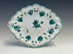 A RED ANCHOR CHELSEA DISH PAINTED WITH A CHAIN OF TURQUOISE FLOWERS SUSPENDED FROM THE LOBED RIM