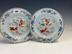 A PAIR OF CHINESE FAMILLE ROSE PLATES CENTRALLY PAINTED WITH FISH WITHIN FOUR OVERGLAZE BLUE
