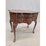 A DUTCH ANTIQUE WALNUT LOWBOY, THE QUARTER VENEERED TOP WITH A SERPENTINE FRONT OVER TWO DRAWERS AND