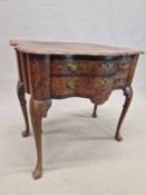 A DUTCH ANTIQUE WALNUT LOWBOY, THE QUARTER VENEERED TOP WITH A SERPENTINE FRONT OVER TWO DRAWERS AND