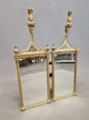 A PAIR OF 19th C. MIRRORS, THE RECTANGULAR PLATES BETWEEN GILT FLUTED COLUMNS AND BELOW TRIANGULAR