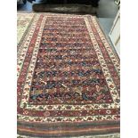AN ANTIQUE PERSIAN TRIBAL CARPET 352 x 176cms