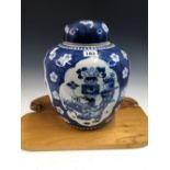 A CHINESE BLUE AND WHITE PORCELAIN GINGER JAR AND COVER PAINTED WITH FOUR RESERVES OF PRECIOUS