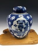 A CHINESE BLUE AND WHITE PORCELAIN GINGER JAR AND COVER PAINTED WITH FOUR RESERVES OF PRECIOUS