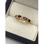 AN 18ct HALLMARKED GOLD RUBY AND DIAMOND HALF ETERNITY STYLE RING. FNGER SIZE Q. WEIGHT 3.42 grams.