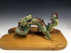 A CHINESE PORCELAIN FOUR HORNED DRAGON, ITS BLUE DIAPERED YELLOW BODY WITH A RED SPINE, SEAL MARKS