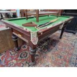 A MAHOGANY QUARTER SIZE SNOOKER TABLE, A SET OF BALLS, A CUE AND A MAHOGANY TRIANGLE TO SET THE