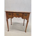 AN 18th C. WALNUT LOWBOY, THE QUARTER VENEERED TOP CROSS BANDED ABOVE THREE DRAWERS AND