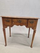 AN 18th C. WALNUT LOWBOY, THE QUARTER VENEERED TOP CROSS BANDED ABOVE THREE DRAWERS AND