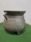 A BRONZE TRIPOD CAULDRON, THE TRIANGULAR HANDLES ATTACHED TO THE FLARED RIM AND ROUNDED SHOULDERS. H