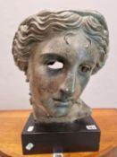 A BRONZED PLASTER HEAD OF A CLASSICAL LADY ON A BLACK PLINTH. H 44cms.