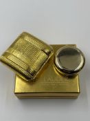 A VINTAGE ESTEE LAUDER GOLDEN PILLOW COMPACT AS NEW IN BOX, TOGETHER WITH AN UNUSED FURTHER ESTEE