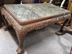 A GREEN STONE TOPPED MAHOGANY LOW TABLE WITH FOLIATE CARVED APRON ON DOLPHIN CABRIOLE LEGS WITH MASK