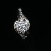 A DIAMOND TWIST CLUSTER RING WITH DIAMOND SET SHOULDERS. STATED DIAMOND WEIGHT 0.50cts.