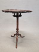 A GEORGE III MAHOGANY BIRDCAGE TRIPOD TABLE, THE DISHED PIECRUST TOP ON A GUN BARREL AND BALUSTER