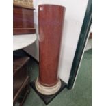 A SIMULATED PORPHYRY CYLINDRICAL COLUMN ON A WHITE MARBLE SOCLE AND SQUARE BLACK SLATE PLINTH. H