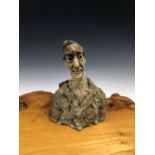 A SCULPTED POTTERY BUST OF A MAN WEARING A BLUE TINTED JACKET. H 21cms.