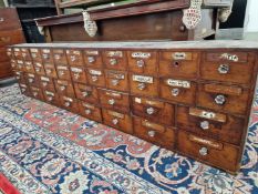 A MAHOGANY APOTHECARYS CHEST, THE FORTY NAMED DRAWERS WITH GLASS KNOB HANDLES. W 243 x D 23.5 x H