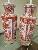 A PAIR OF CHINESE VASES MOUNTED AS TABLE LAMPS AND DECORATED WITH IRON RED FLOWERS, THE OVERALL