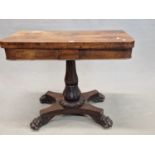 A 19th C. ROSEWOOD SWIVEL TOP GAMES TABLE SUPPORTED ON A FOLIATE BASED OCTAGONAL BALUSTER COLUMN AND