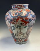 AN 18th C. JAPANESE IMARI JAR PAINTED WITH RESERVES OF CRANES, A BIRD FLYING OVER A STREAM AND OF