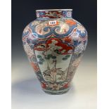 AN 18th C. JAPANESE IMARI JAR PAINTED WITH RESERVES OF CRANES, A BIRD FLYING OVER A STREAM AND OF