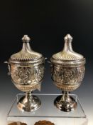 A PAIR OF ANTIQUE HALLMARKED SILVER CLASSICAL STYLE CUPS AND COVERS EACH WITH MASK HANDLES . CHESTER
