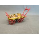 A FOUR WHEEL RED AND YELLOW HAY WAIN, THE WHEELS WITH METAL TREADS, THE CART CONTAINING A MODEL