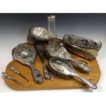 A SILVER BACKED DRESSING TABLE SET, BIRMINGHAM 1924, EACH PIECE WITH A MAN PLAYING A MANDOLIN TO TWO