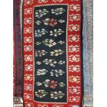 A KELIM RUG OF UNUSUAL DESIGN TOGETHER WITH A TRIBAL FLAT WEAVE PANEL (2)