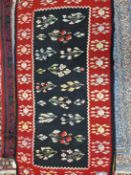 A KELIM RUG OF UNUSUAL DESIGN TOGETHER WITH A TRIBAL FLAT WEAVE PANEL (2)