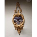 A PAIR OF CONVEX GIRANDOLE MIRRORS THE GILT FRAMES WITH TRIANGULAR VINE TOP SUPPORTS, THE CRESTING