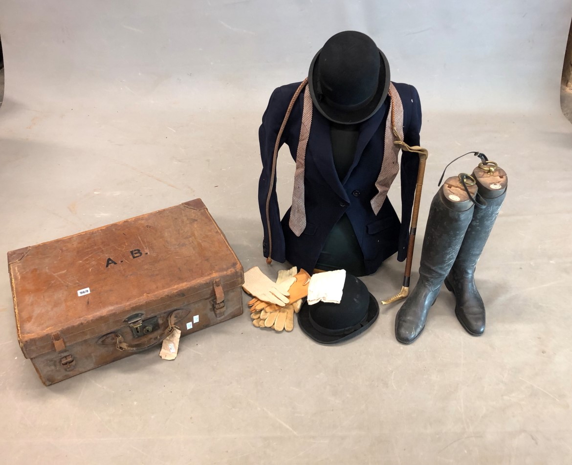 A LEATHER SUITCASE CONTAINING A LADYS BLUE HUNTING JACKET BY RICHARDS AND SON, BLACK BOWLER HATS