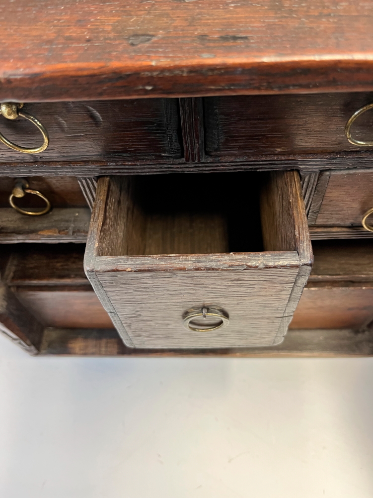 AN 18th C. OAK TABLE TOP CABINET, THE X-SHAPED PANELLED DOOR OPENING ONTO SIX DRAWERS AND TWO PIGEON - Image 7 of 14